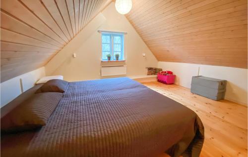 a bedroom with a large bed in a attic at Cozy Home In Hishult With Kitchen in Knäred