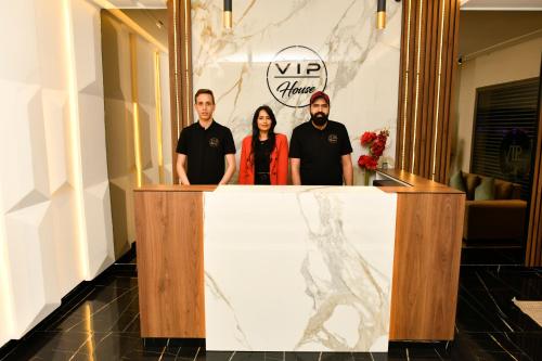 a group of three people standing behind a podium at Vip House Résidence in Sousse