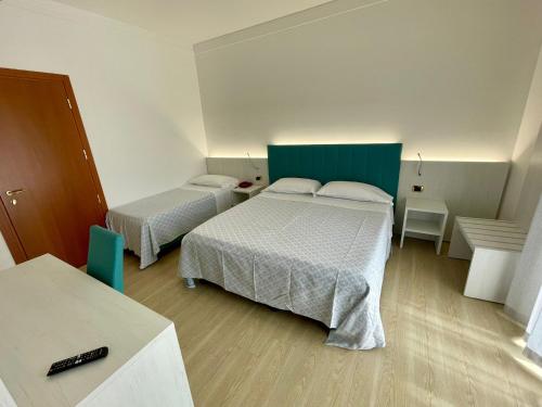 Postel nebo postele na pokoji v ubytování Hotel Corallo