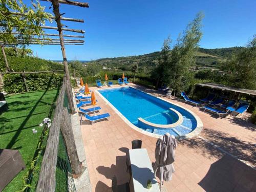 a swimming pool with lounge chairs and a swimming poolvisor at Il Girasole Country Village in Massignano
