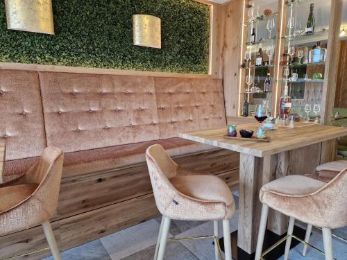 a bar with two chairs and a wooden table at Wellnesshotel Sonnenhof & Sonnhalde in Ühlingen-Birkendorf