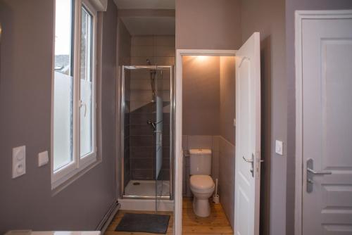 a bathroom with a toilet and a glass shower at Gite Amiens in Amiens