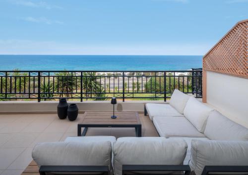 a living room with a couch and a view of the ocean at Zuzu Riviera Living in Hersonissos