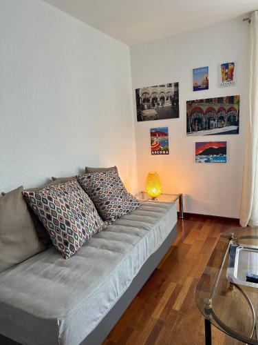 a living room with a couch and a table at Appartamento Ascona Vista Lago in Ascona