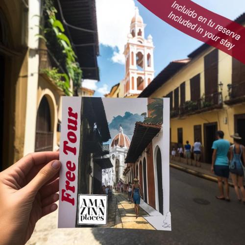 a person holding a magazine in front of a street at AmazINN Places Casco Viejo Pool and Rooftop V in Panama City