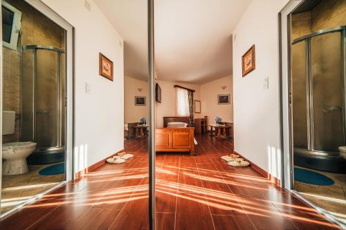 a hallway with a wooden floor and a toilet at Guest house Šebelj in Budva