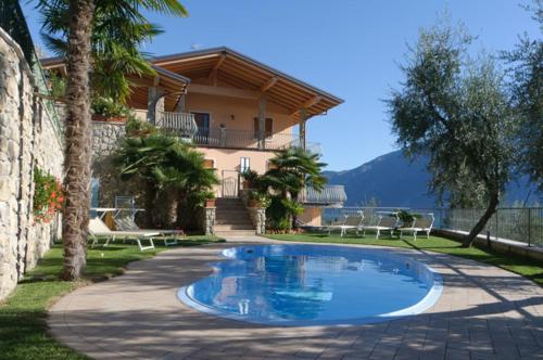 a swimming pool in front of a house at Hotel Florida in Limone sul Garda