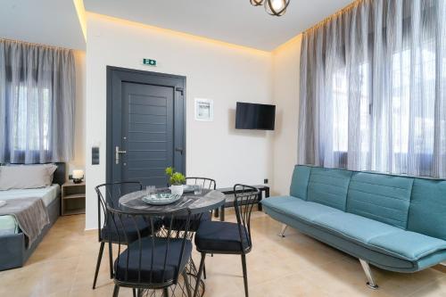 a living room with a couch and a table and chairs at Giorgio Suites in Asprovalta
