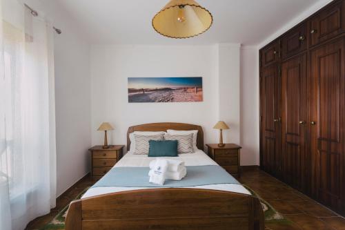 a bedroom with a bed with two towels on it at Best Houses 85 - Sea breeze at Consolação Beach in Atouguia da Baleia