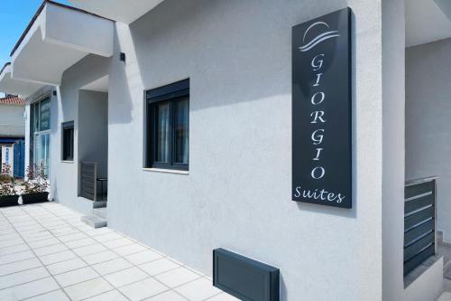 a sign on the side of a building at Giorgio Suites in Asprovalta