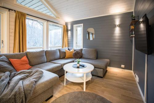 a living room with a couch and a table at Tromsø Lodge & Camping in Tromsø