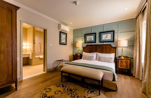 a bedroom with a large bed and a bathroom at Gold Reef City Theme Park Hotel in Johannesburg