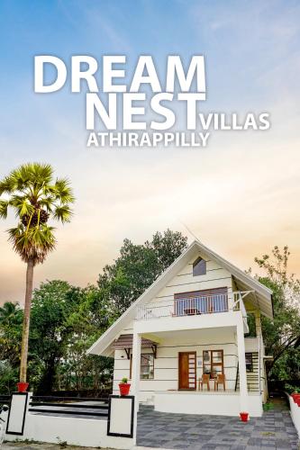 a small white house with a palm tree at Dream Nest Villas Athirappilly in Athirappilly