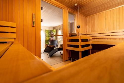 a person sitting in a chair in a room at Apartment Felswelten in Bielatal