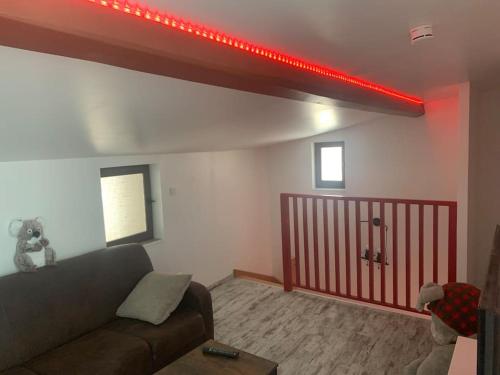 a living room with a couch and a red light at Maison entière avec sauna privatif Sauna sur Sye in Aouste-sur-Sye