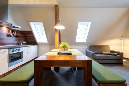 a kitchen and living room with a table and a couch at Apartment Felswelten in Bielatal