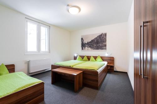 a bedroom with two beds with green sheets at Apartment Felswelten in Bielatal