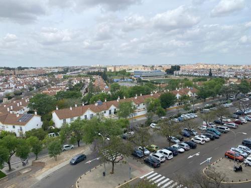 a city with cars parked in a parking lot at Habitación luminosa en piso compartido in Mairena del Aljarafe