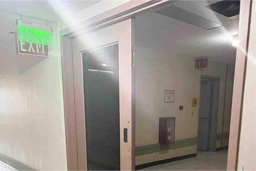 a exit sign on the side of a building at One Bedroom Condo Subic Bay in Morong