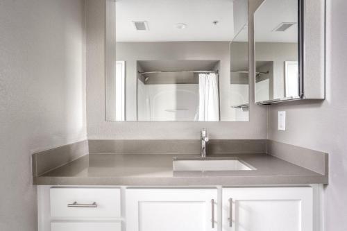a bathroom with a sink and a mirror at Santana Row 2br townhouse w pool nr highways SFO-1327 in San Jose