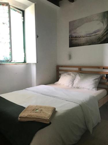 a bedroom with two beds with a tray on it at GetWet SurfCamp II in Costa da Caparica