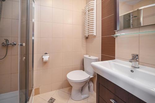 a bathroom with a toilet and a sink and a shower at Wanta in Zakopane