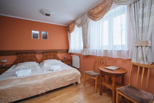 a bedroom with a bed and a table at Wanta in Zakopane