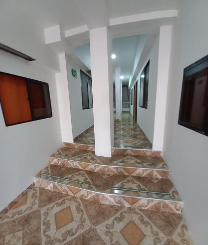 a hallway in a house with a tile floor at Hotel San Adolfo Carepa in Carepa