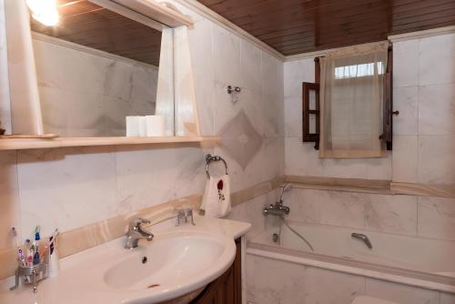 y baño con lavabo y bañera. en Sunshine Villa en Vasilikós