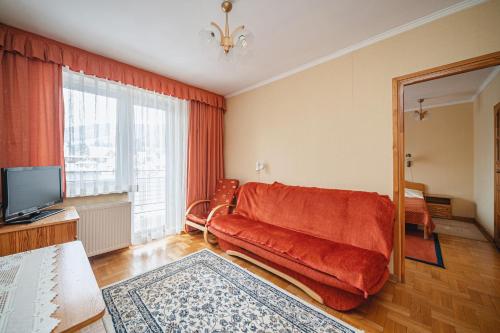 a living room with a couch and a television at Wanta in Zakopane