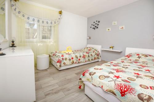 a bedroom with two beds and a sink at Apartment Iryna in Rogoznica