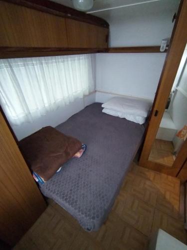 a small room with a bed in the middle of it at Camping Roma in Ventimiglia