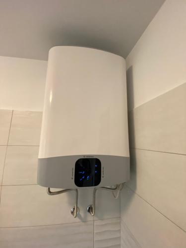 a white light on a wall in a bathroom at Apartma Magnolija in Nova Gorica