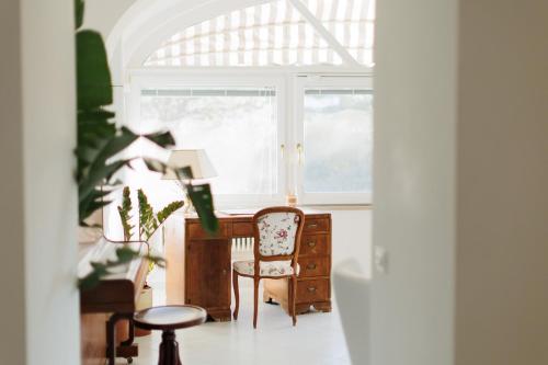 a room with a desk and a chair and a window at Villa l'Approdo in Anacapri
