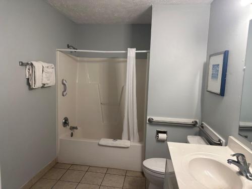 a bathroom with a shower and a toilet and a sink at Pirates Cove in Carolina Beach