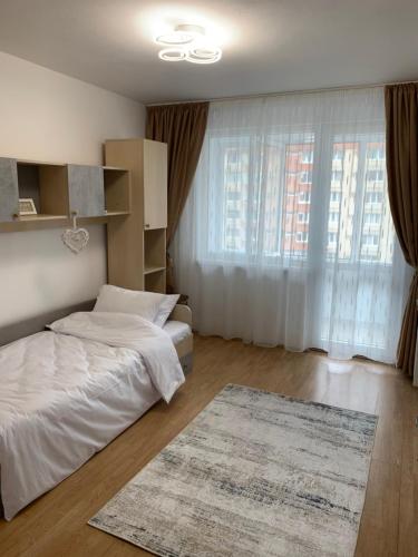 a bedroom with two beds and a rug at Victoriei Boulevard Private Apartment in Braşov