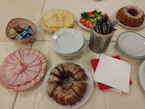 a table topped with plates and bowls of food at Hotel Centrum Brno in Brno