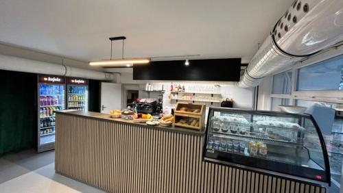 a restaurant with a counter with food and a refrigerator at Hotel Centrum Brno in Brno