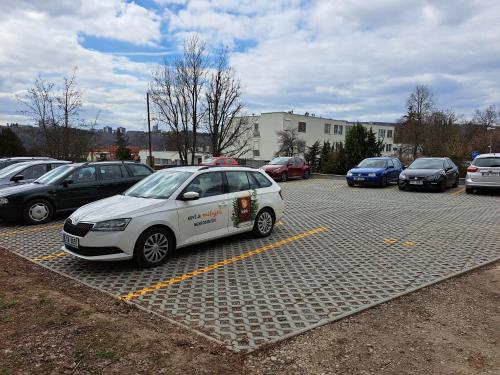 a white car parked in a parking lot at Hotel Centrum Brno in Brno