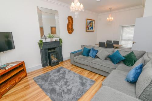 a living room with a couch and a fireplace at Lodge at The Old Barracks in Athenry