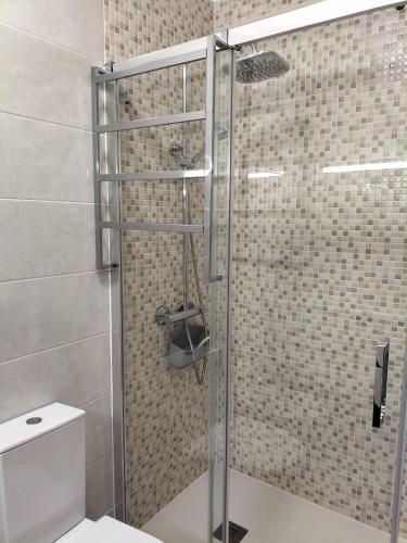 a shower with a glass door in a bathroom at T2 Vista Atlantica 3 minutos da praia de Quarteira in Quarteira