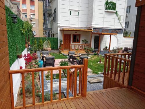 a balcony with a wooden railing and a yard at My Home Hotel Gulluk in Antalya