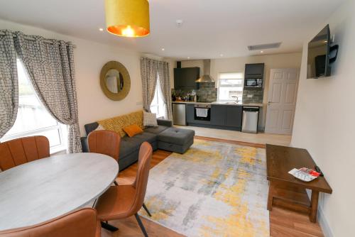 a living room with a couch and a table at Lodge at The Old Barracks in Athenry