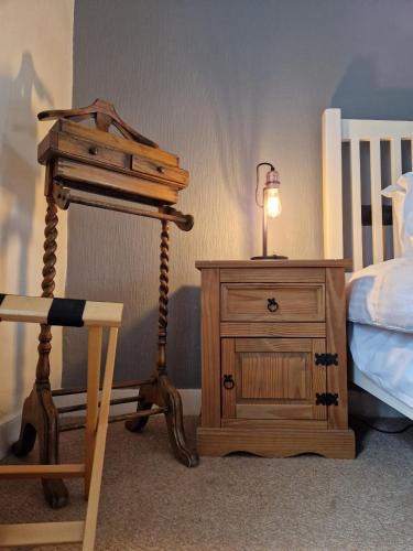 a lamp on a night stand next to a bed at The Jolly Sailor, Orford in Orford