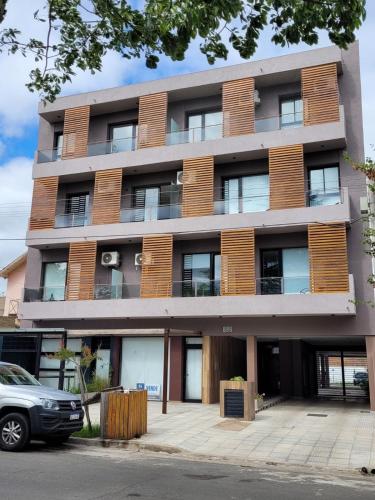 an apartment building with a car parked in front of it at FINCA NOVA Apartment 1 in Balcarce