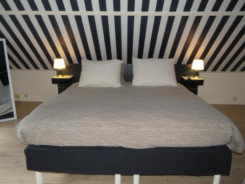 Кровать или кровати в номере B&B aan het Spuikompark