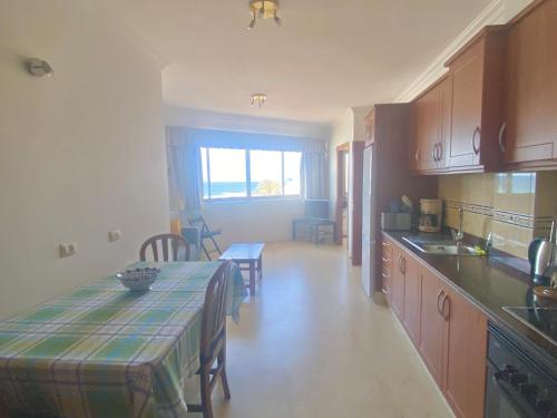 a kitchen with a table and a dining room at Gomera Sunset Apartments in Valle Gran Rey