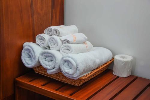 a pile of towels sitting on top of a basket at Tranquill Villa La Dimora in Gampaha