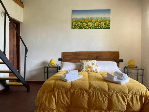 a bedroom with a bed with two towels on it at AgriHouse Orvieto in Morrano