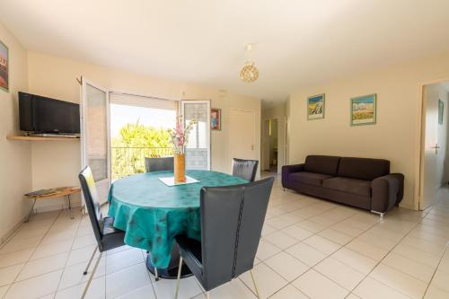 sala de estar con mesa y sofá en Gîte L'Orée du Lac, en Carcassonne